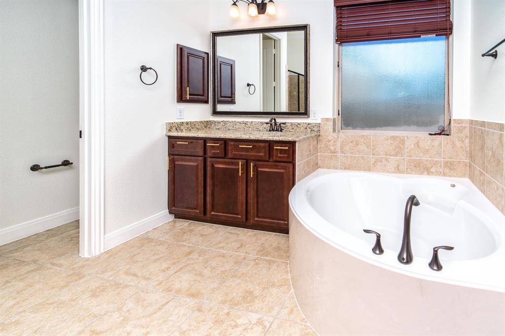 Master bath retreat with a double vanity, soaking tub, and walk-in shower.