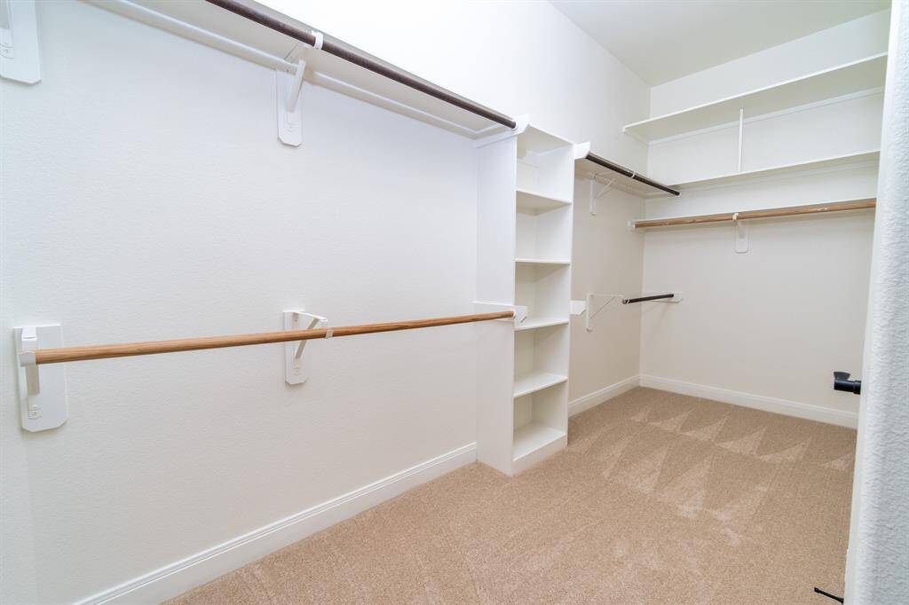 Walk-in master closet with plenty of shelves and storage space. The bonus shelf with a door offers extra security and privacy.