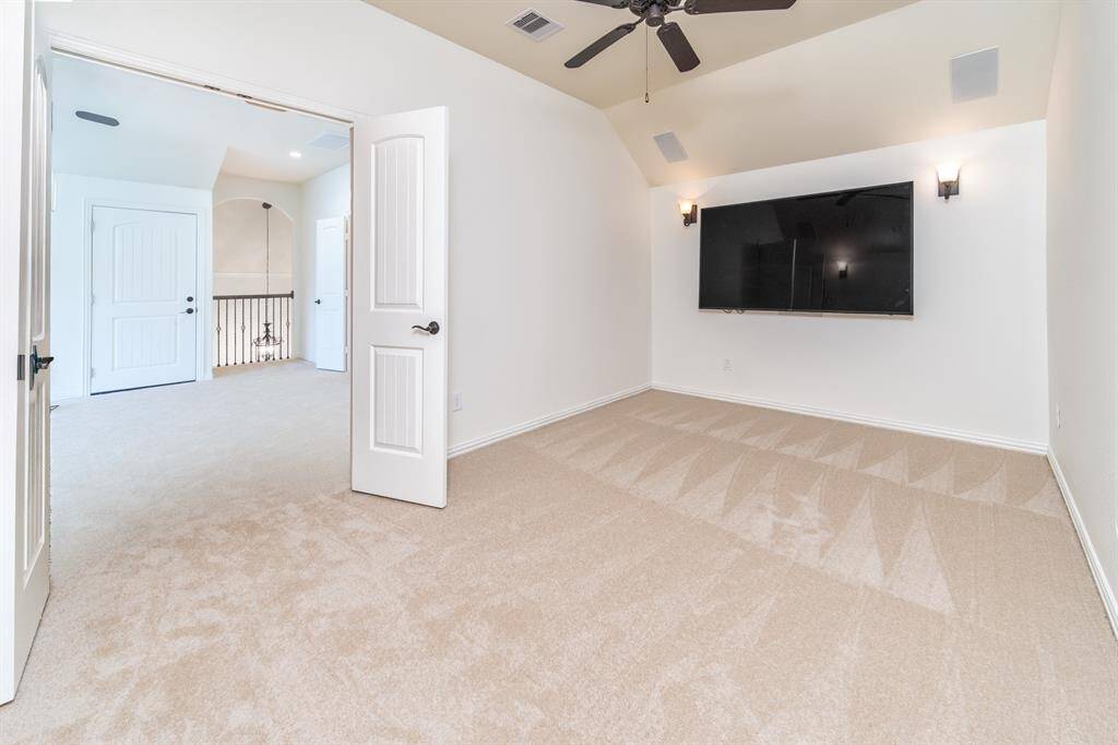 The ultimate entertainment space! A media room with an oversized TV and seamless built-in ceiling speakers is ready for movie nights!