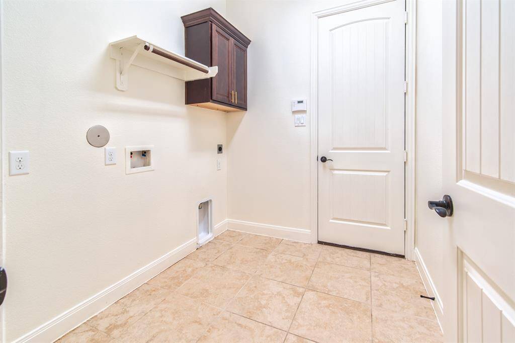 Convenient mudroom with washer/dryer hookups and storage space.