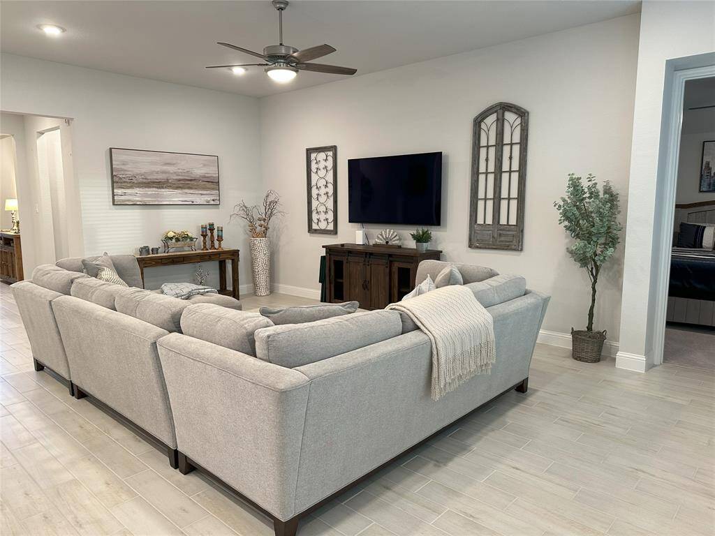 Spacious living room ideal for entertaining, with a wall of windows that fill the space with natural light.