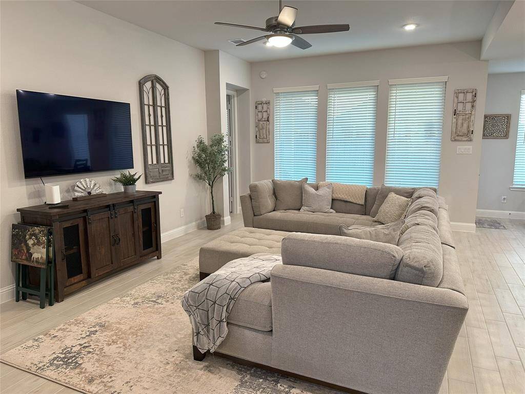 Abundant recessed lighting throughout, complemented by a ceiling fan with light, creating a bright and inviting atmosphere.