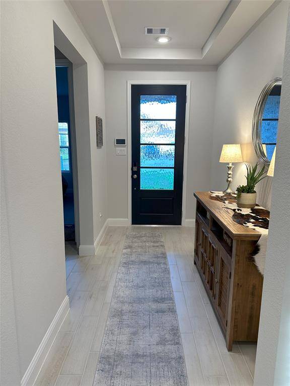Elegant front entry featuring stylish tile flooring and a stunning coffered ceiling—an impressive welcome to this beautiful home.