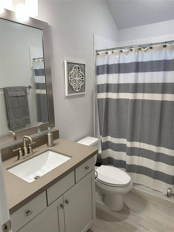 Versatile secondary bedroom currently used as a home office provides ample lighting.