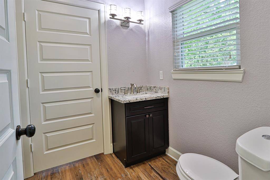 a granite countertop vanity with a brushed nickel faucet