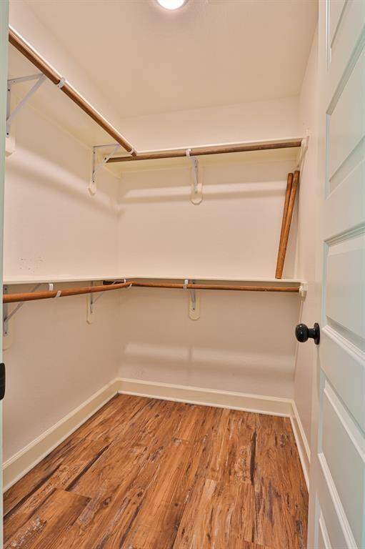 This well-lit walk-in closet offers the perfect blend of style and functionality, designed to keep your wardrobe organized and accessible