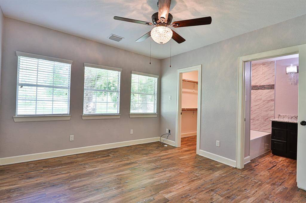 Step into tranquility with this inviting primary bedroom, designed to offer both elegance and functionality.This bedroom boasts a walk-in closet with built-in shelving and ample hanging space.