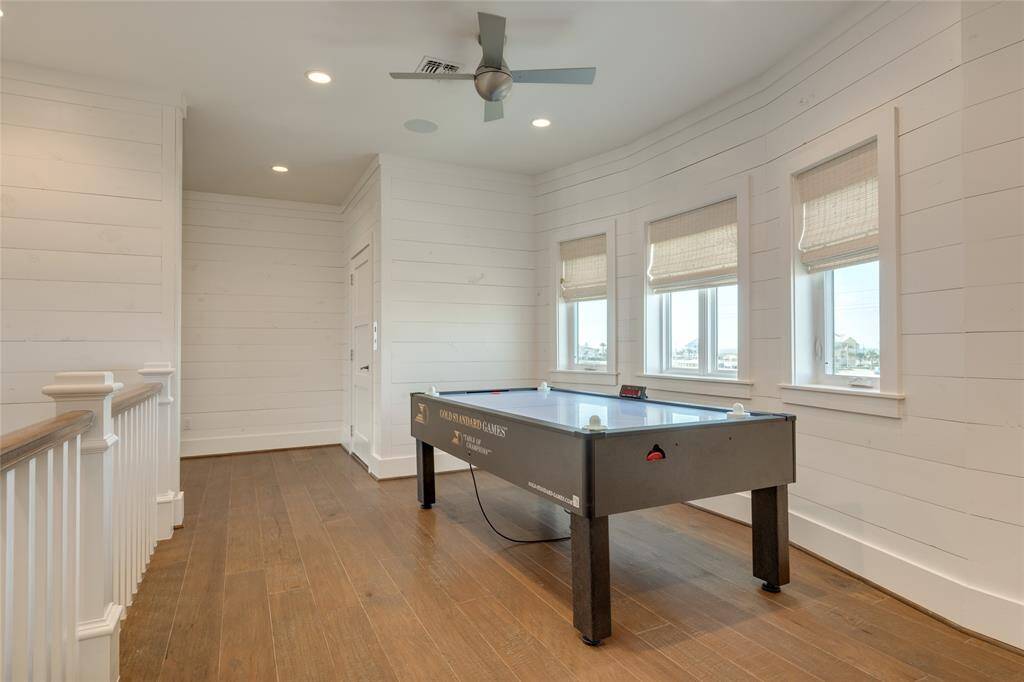 The upstairs landing can be used as a gaming area, office, or lounge. Windows look out to the Bay
