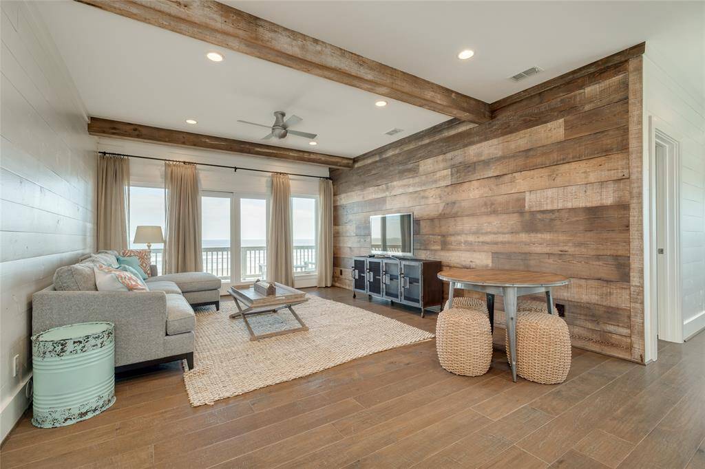 Upstairs living area has a beautiful accent wall of reclaimed wood