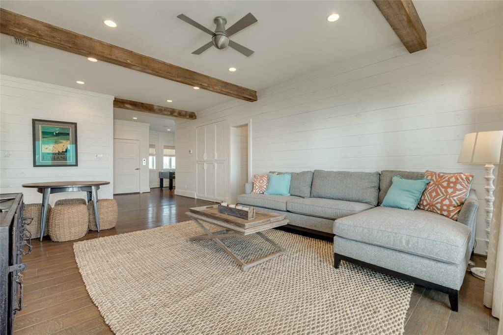 The designer continued the use of wood beams and shiplap walls upstairs