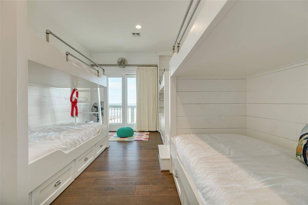 Bedroom 5 has 3 sets of built-in bunk beds. It also has an attached bathroom that has a double vanity and a tub with shower