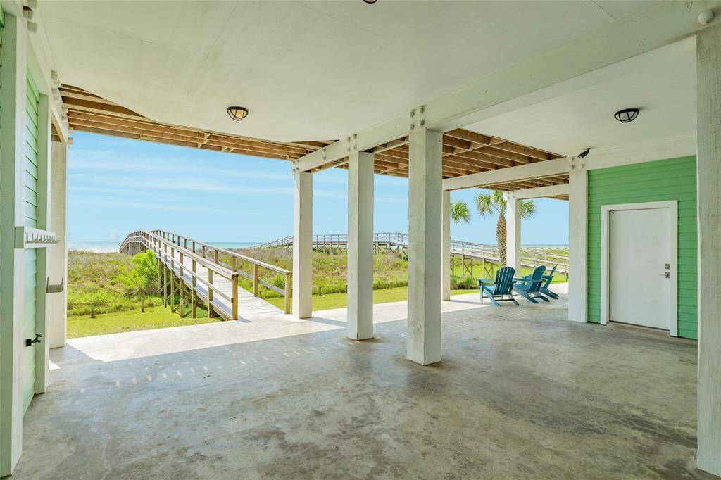 Two-car garage is to the right, additional storage area is to the left. Private walkover takes you right to the beach
