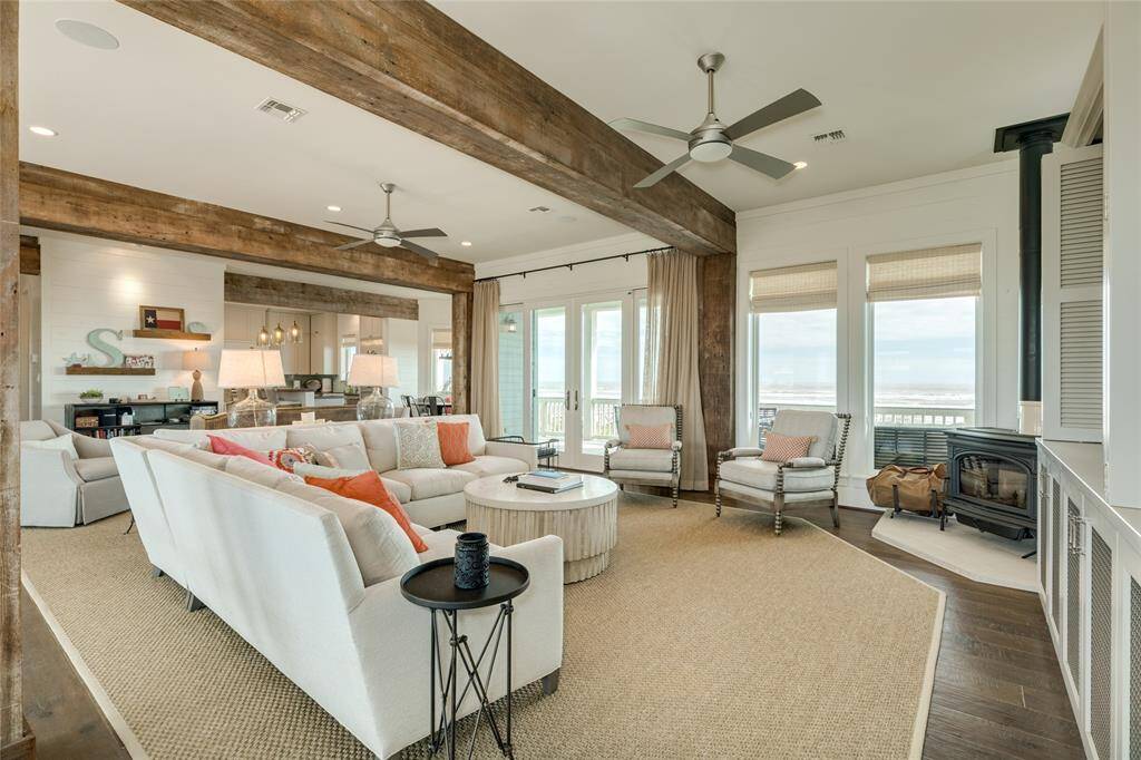Great Room features shiplap walls, ten-foot ceilings, and a cast iron wood-burning stove