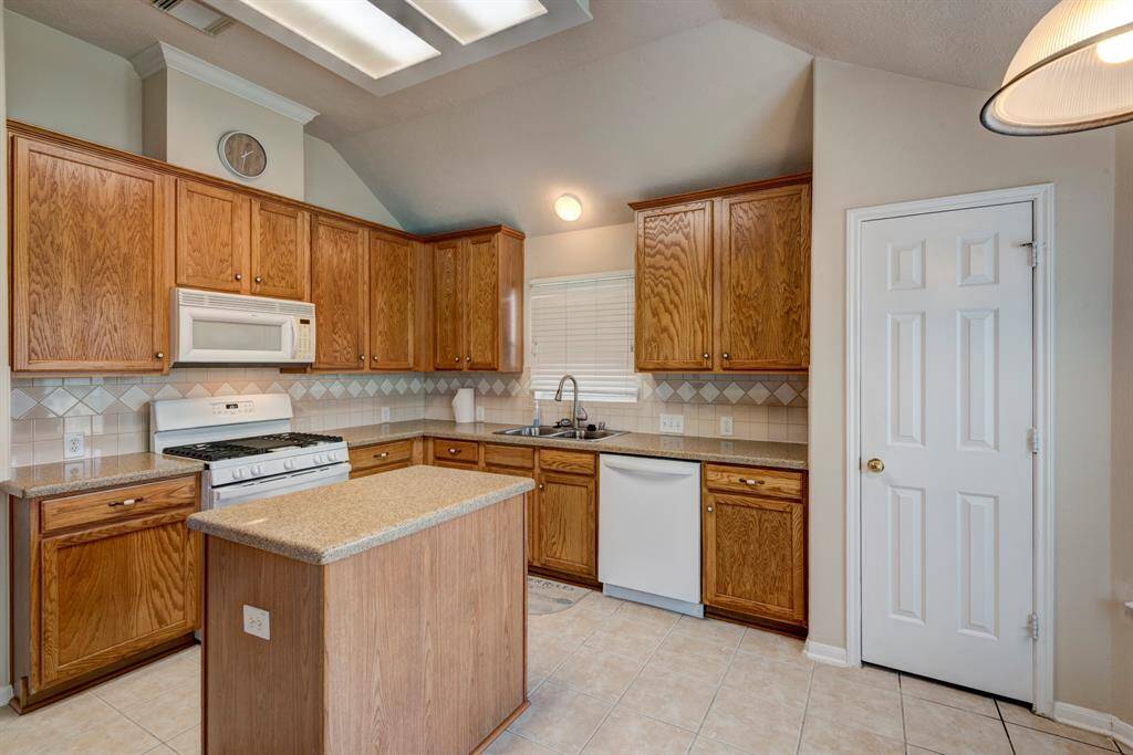 Noticing the full pantry and the raised ceiling detail.