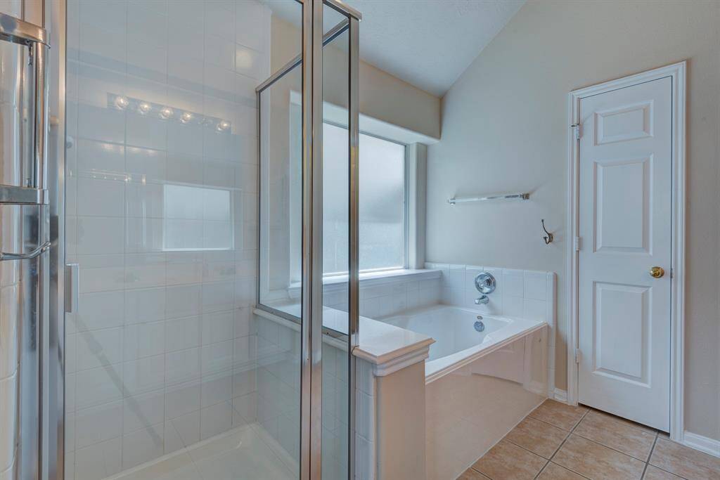 Features garden tub and separate shower.