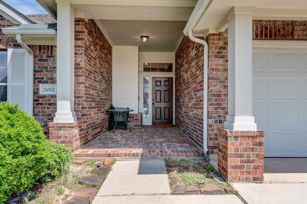 An absolutely charming brick front patio entry