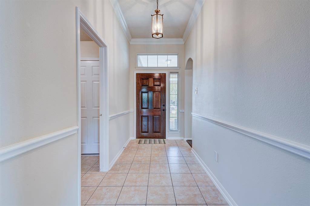 You're greeted by a formal foyer made bright with side and transom windows.