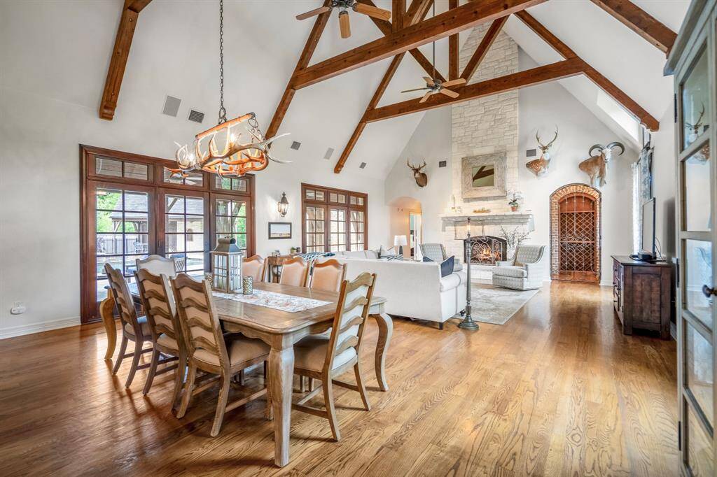 Experience the perfect blend of elegance and warmth in this inviting space, featuring beamed ceilings, a stunning stone fireplace, and rich wood floors.
