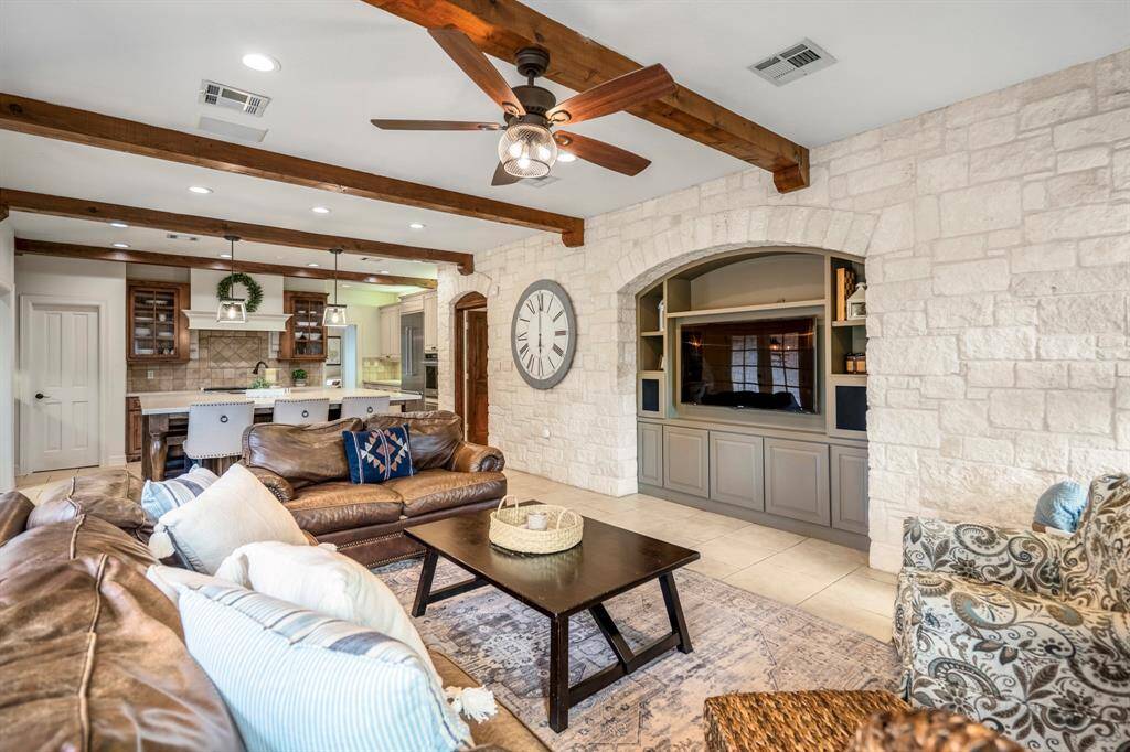 Stting room seamlessly flows into a stylish kitchen, perfect for entertaining.