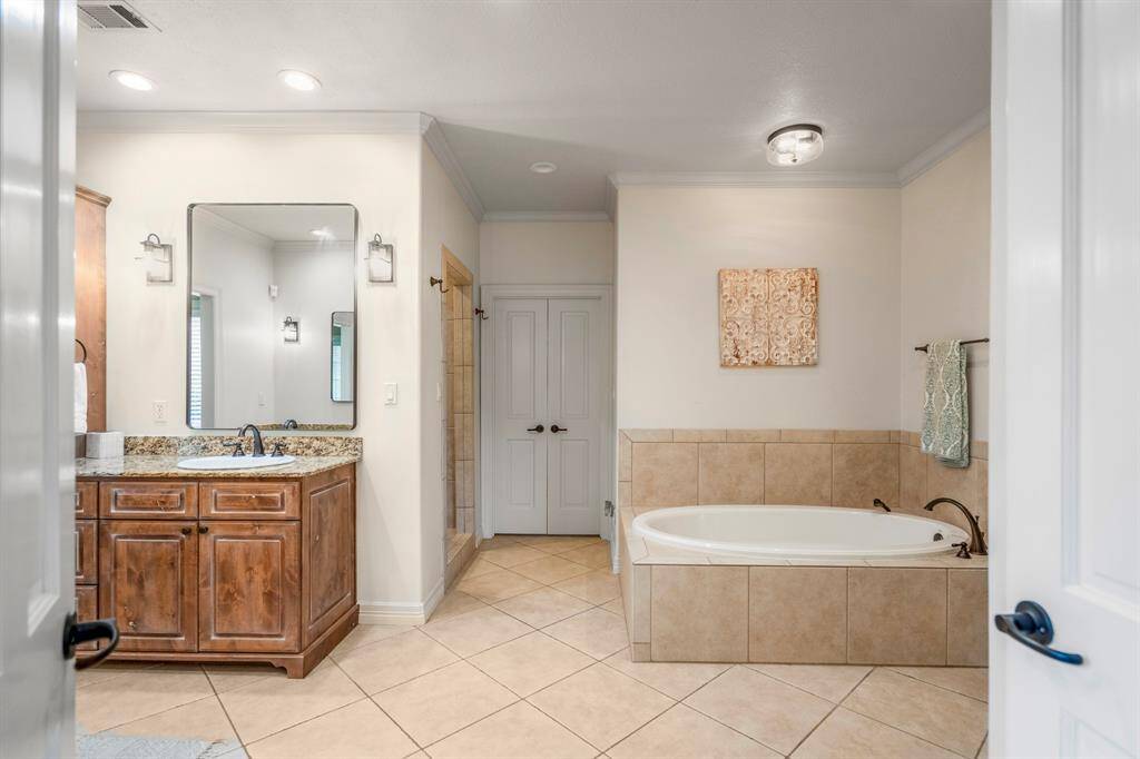 Primary bathroom featuring a relaxing soaking tub.