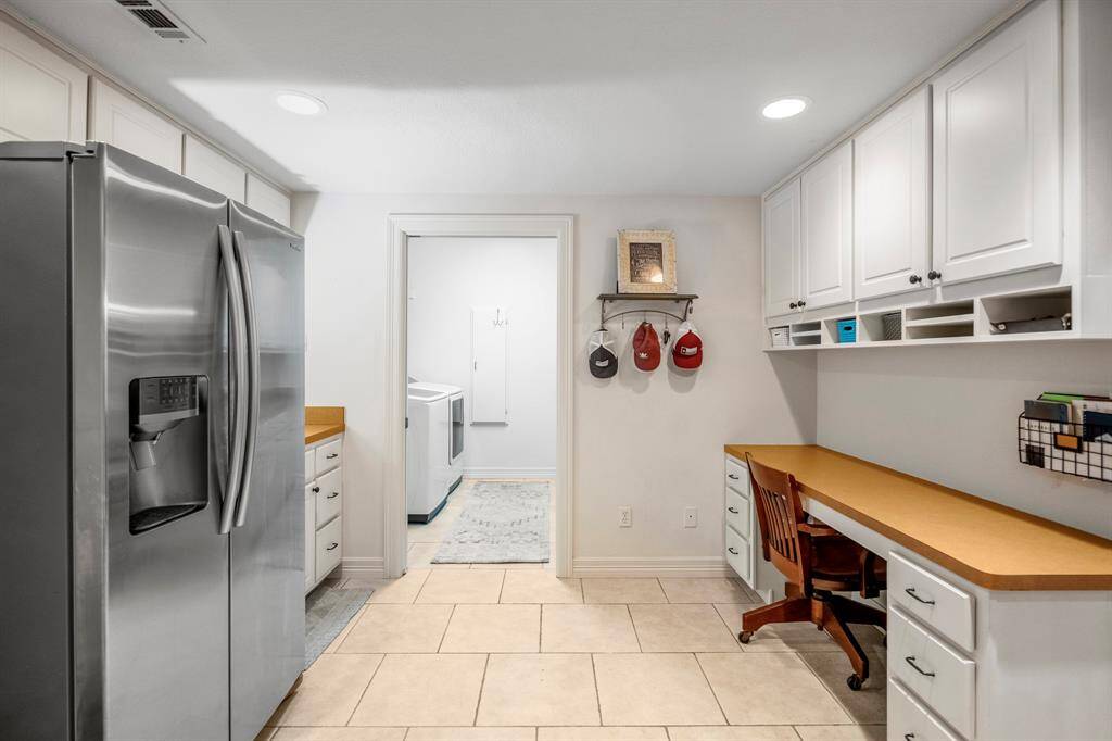 Spacious utility and laundry area with a convenient workspace.