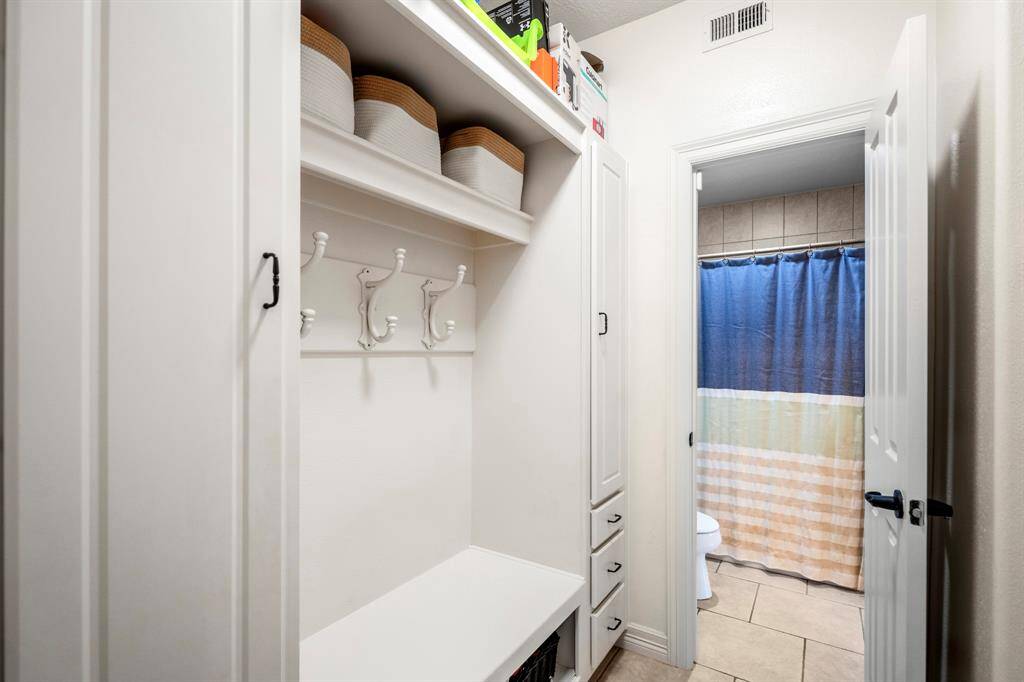 Efficient mudroom with ample storage, convenient hooks, and easy access to the bathroom, perfect for keeping your home organized and tidy.