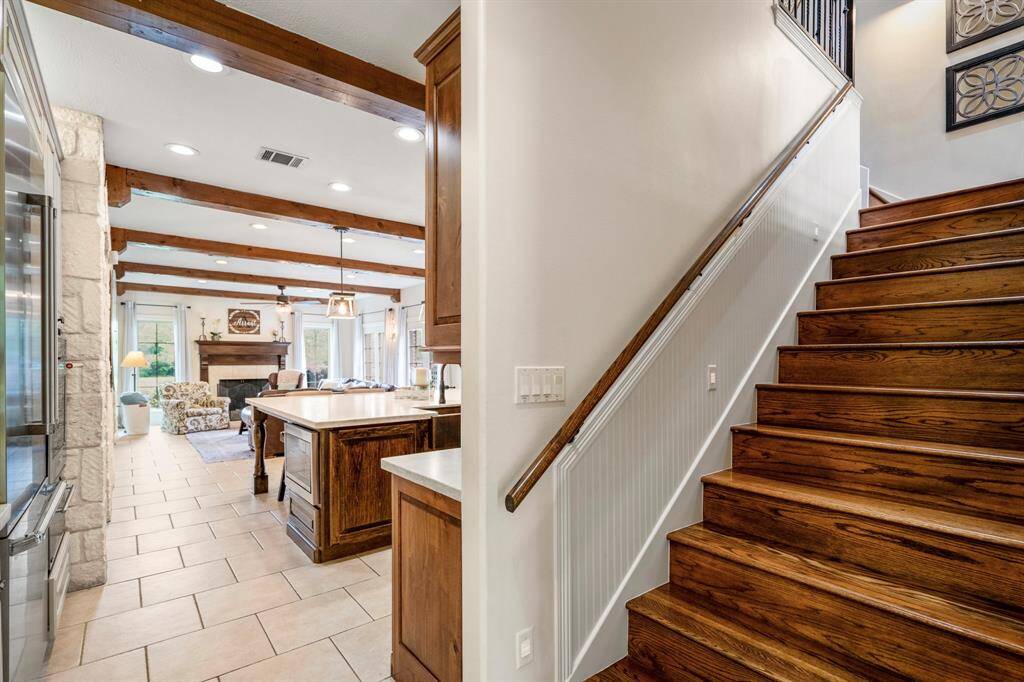 The stairs are tucked away at the back of the kitchen.