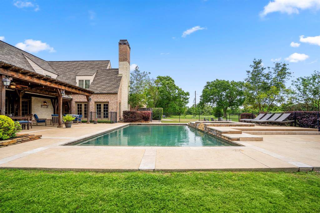 The pool space is adjacent to the custom putting green.