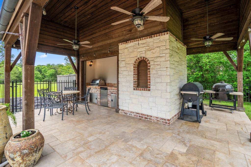 The pool also features a dining and grilling area.  On the back of this area is the pool bath and outdoor shower.