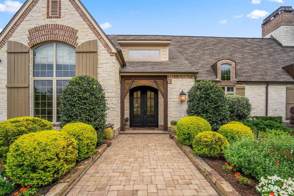 Elevate your entrance with a charming covered entryway and NEW elegant solid metal double doors.