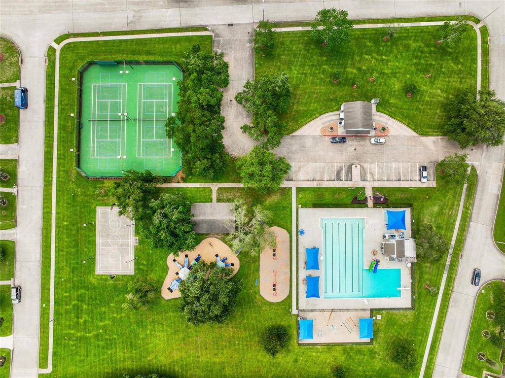 Aerial view of the community pool, park, tennis courts & basketball courts.