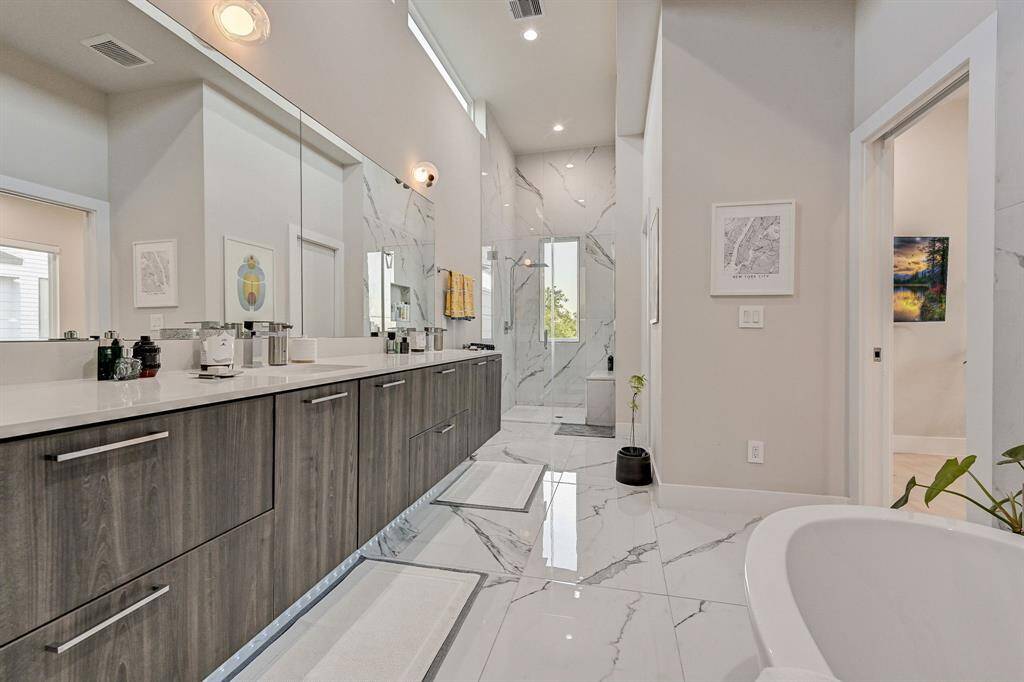 Double floating vanity with under cabinet lighting and walk in shower