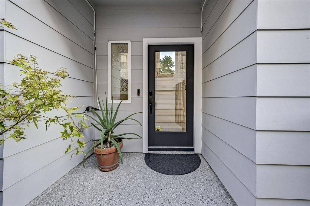 Front entry that leads to the interior garage door and downstairs suite.