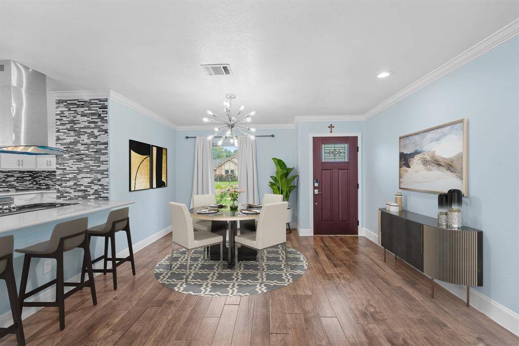 Virtually Staged: This dining area boasts a gorgeous chandelier, beautiful wood look tile floors, high ceilings, and pure elegance!