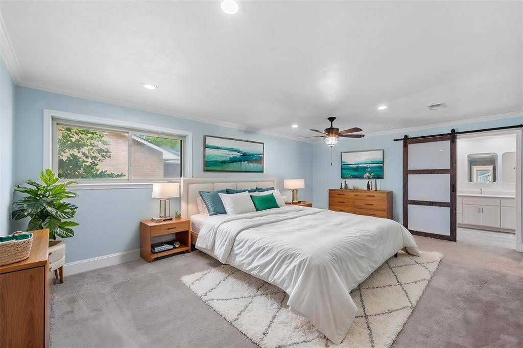 Virtually Staged: A great place to rest after a long day! This magnificent master suite features carpet floor, beautiful dark stained ceiling fan, recessed lighting, and a large window!