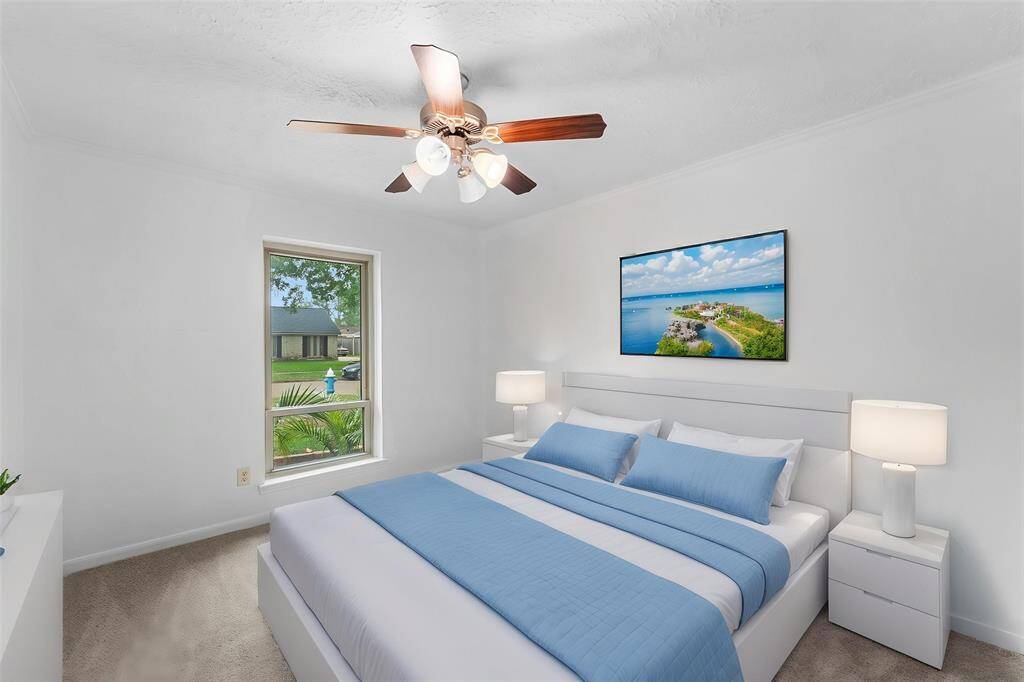 Virtually Staged: Beautiful Secondary Bedroom complete with carpet floor, a ceiling fan, and a large window.