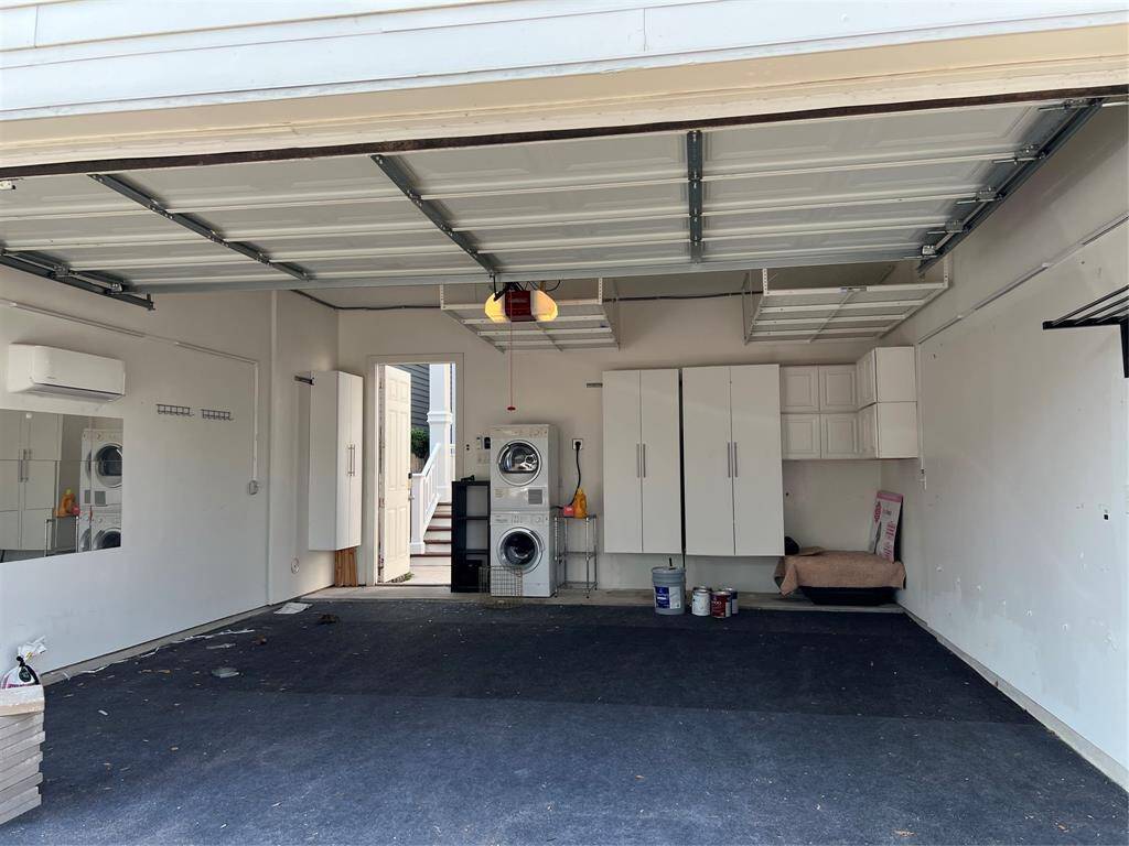 Two car garage with built in storage. There is an A/C in the garage. Washer/Dryer is for the tenant that lives in the garage apartment.