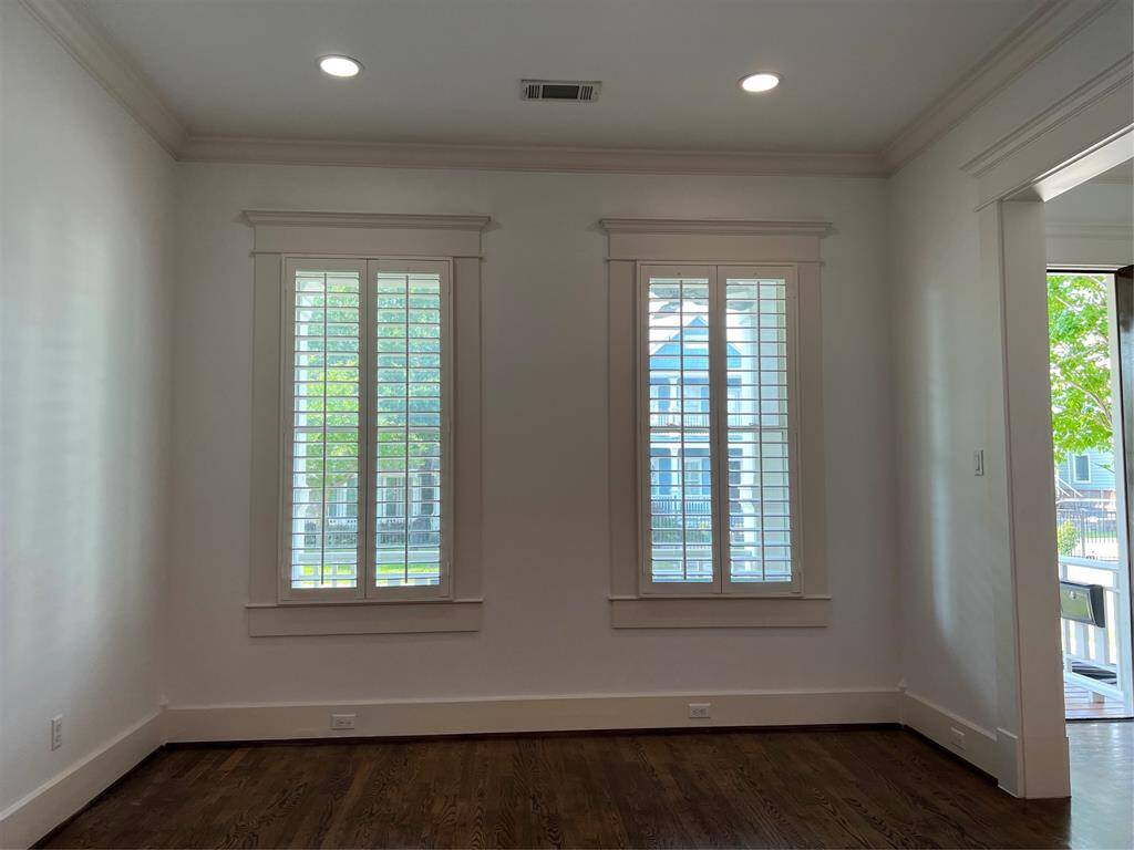 The formal living room is light and bright. The house has wide shutters throughout the house.