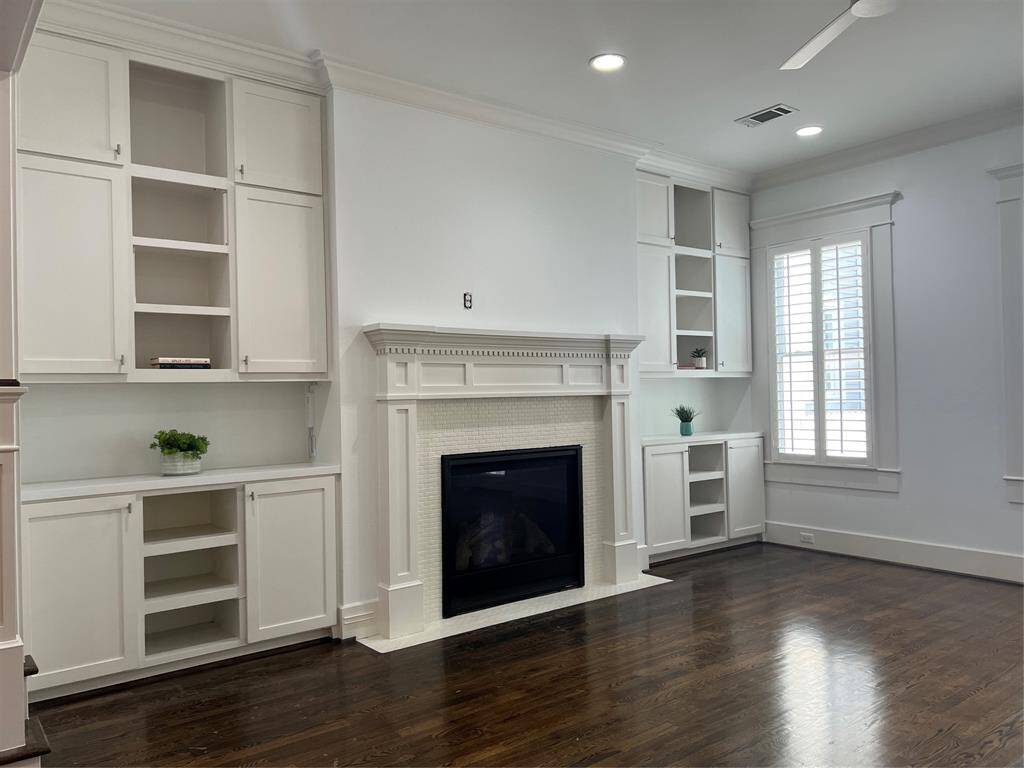 Family Room in the back of the house offers built in shelves and a fireplace.