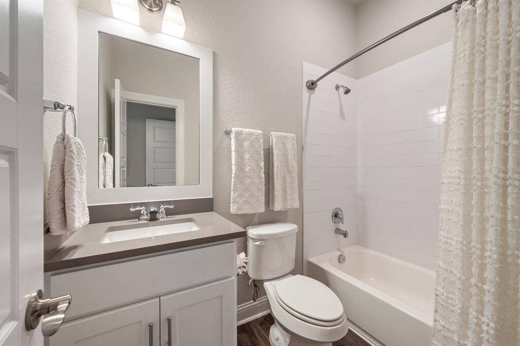 Minimalistic luxury inside this en suite bathroom adjacent to cozy spare room.
