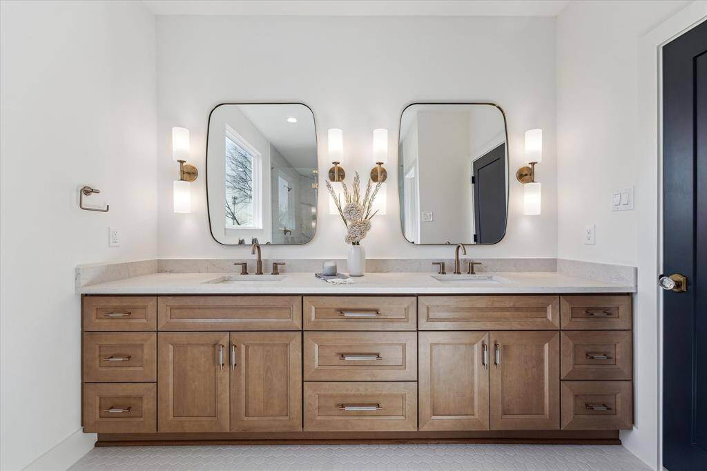 Show stopper primary bathroom featuring double sinks.