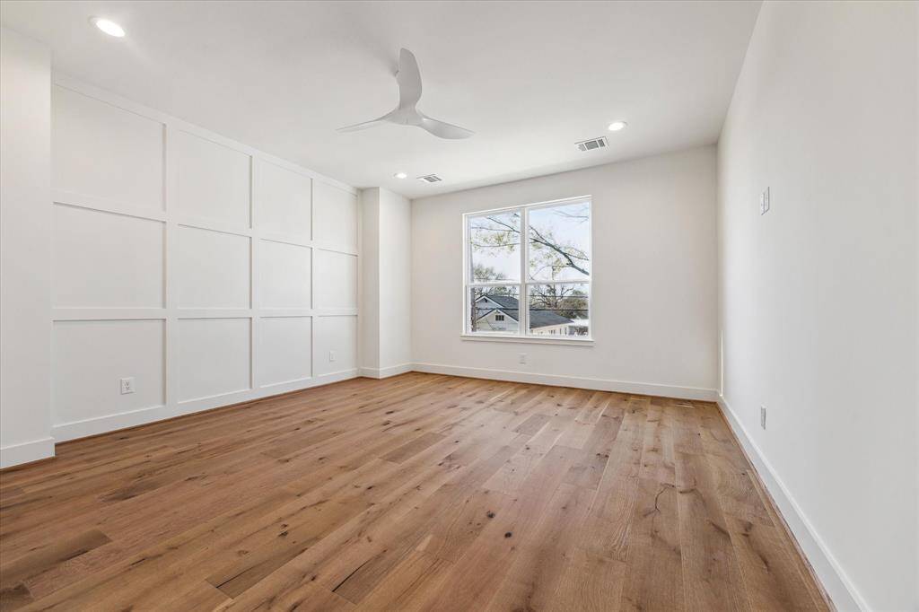 Primary bedroom features a aesthetically pleasing batten wall.