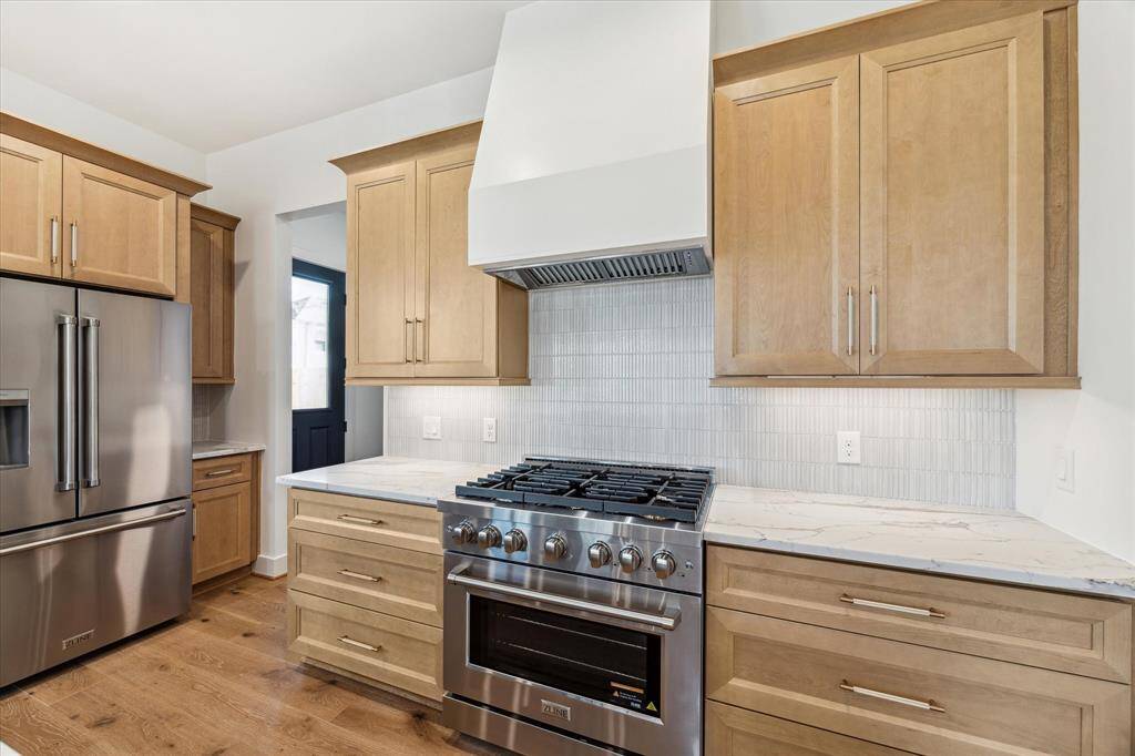 Gorgeous gas oven and stove with exquisite, fluted tile backsplash.