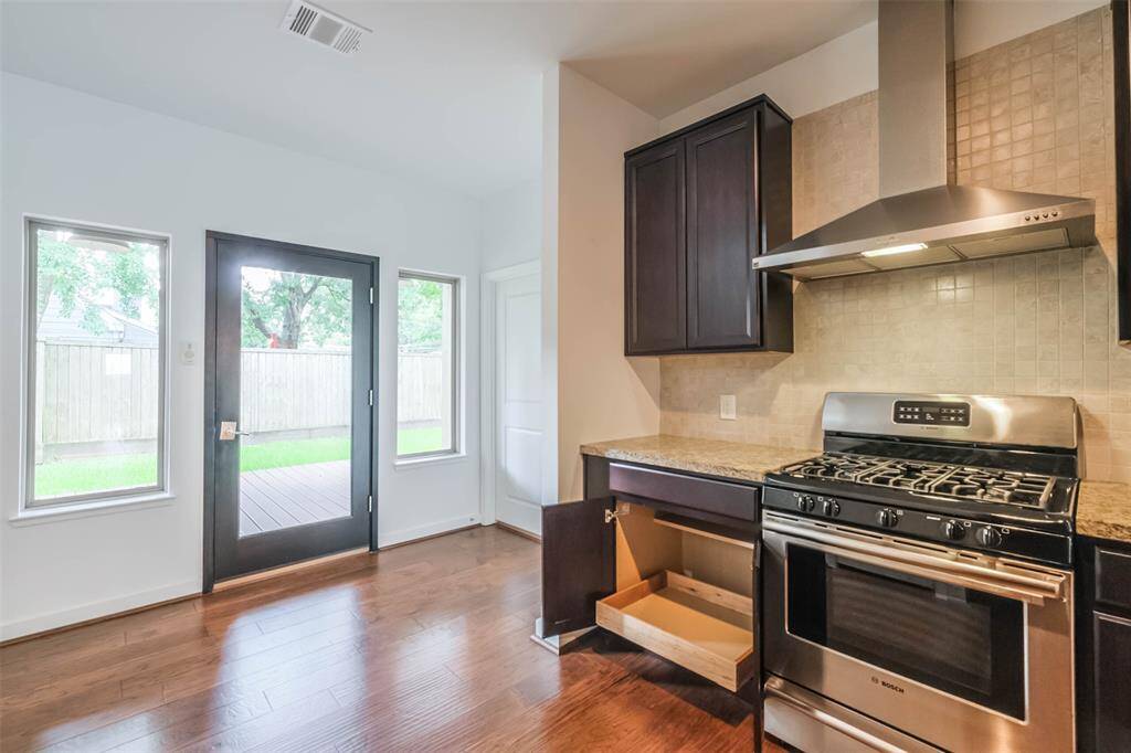 Some of the cabinets offer pull out shelves. To the right of the back door is the large utility room.