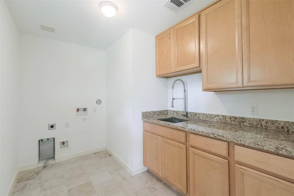 The laundry room is large and could double as a butler's pantry when entertaining.  This home doesn't lack storage cabinets, nor linen closets.