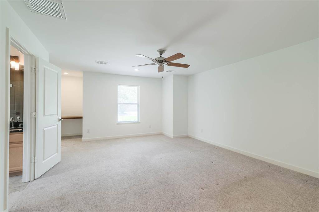 The primary bedroom is spacious and private with its own luxurious bath and large closet.