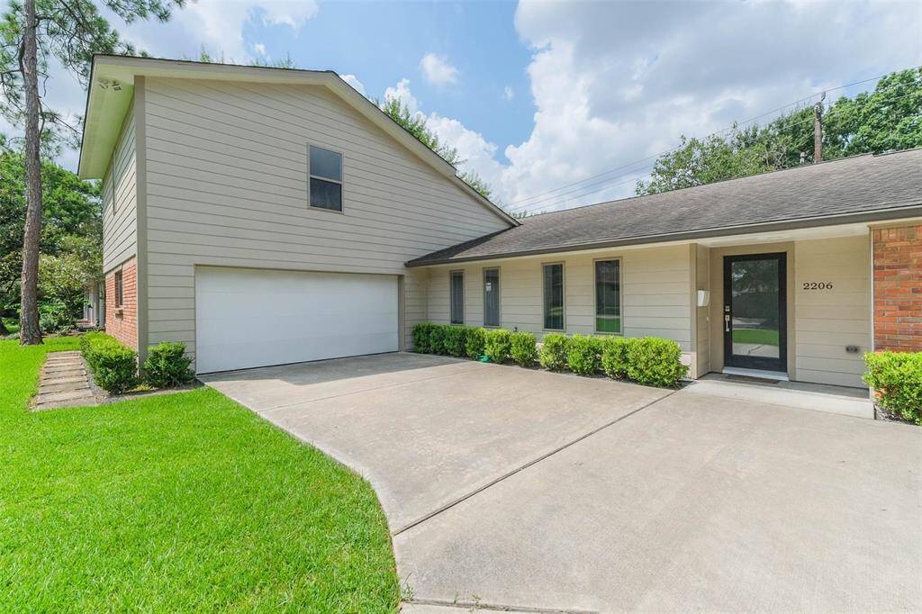 With its spacious attached garage and large driveway, it offers practical parking for several vehicles.