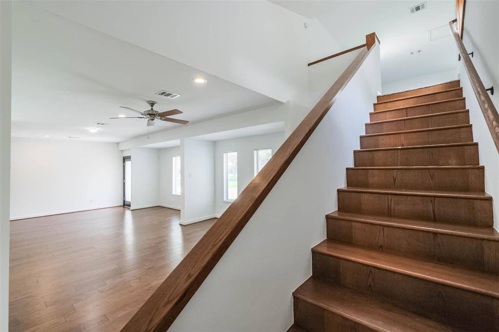 Beautiful wood stairs lead to the oversized game room