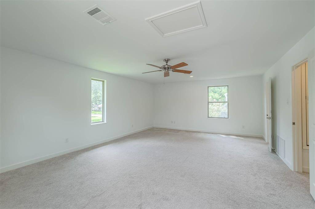 This large game room can be used as you wish.  Light and bright.  It has its own half bath and a small closet for storage.  A good portion of the attic above is decked.