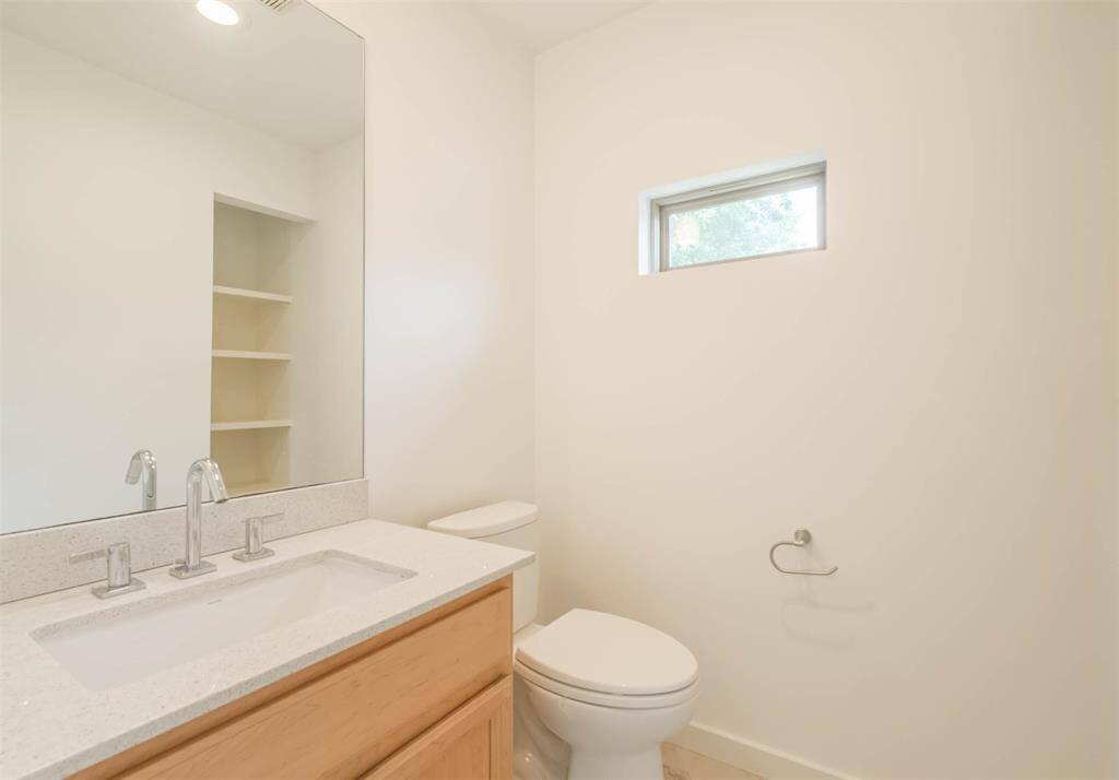 Gameroom half-bath with storage shelves